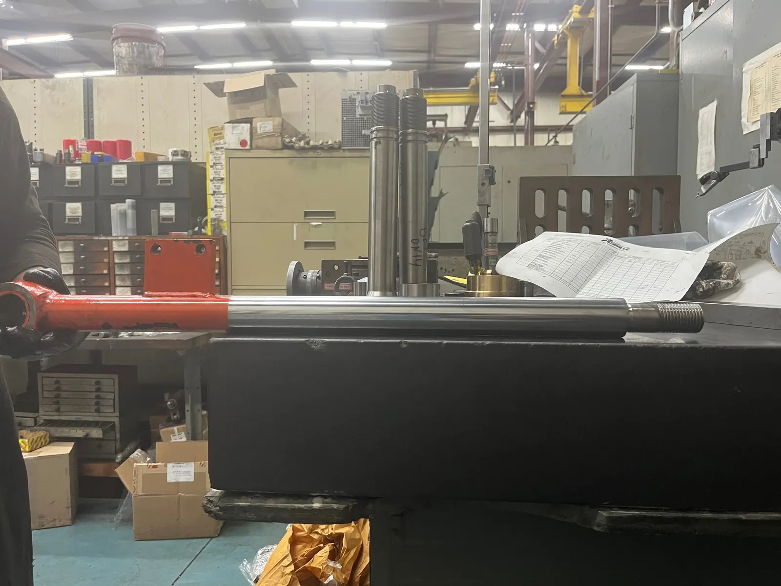 Reidville Hydraulics machine shop floor showing a hydraulic cylinder mounted on the honing machine