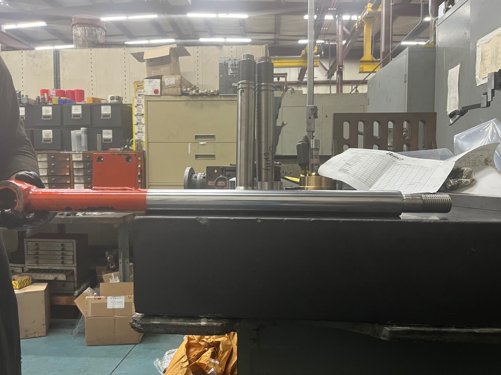 Reidville Hydraulics machine shop floor showing a hydraulic cylinder mounted on the honing machine