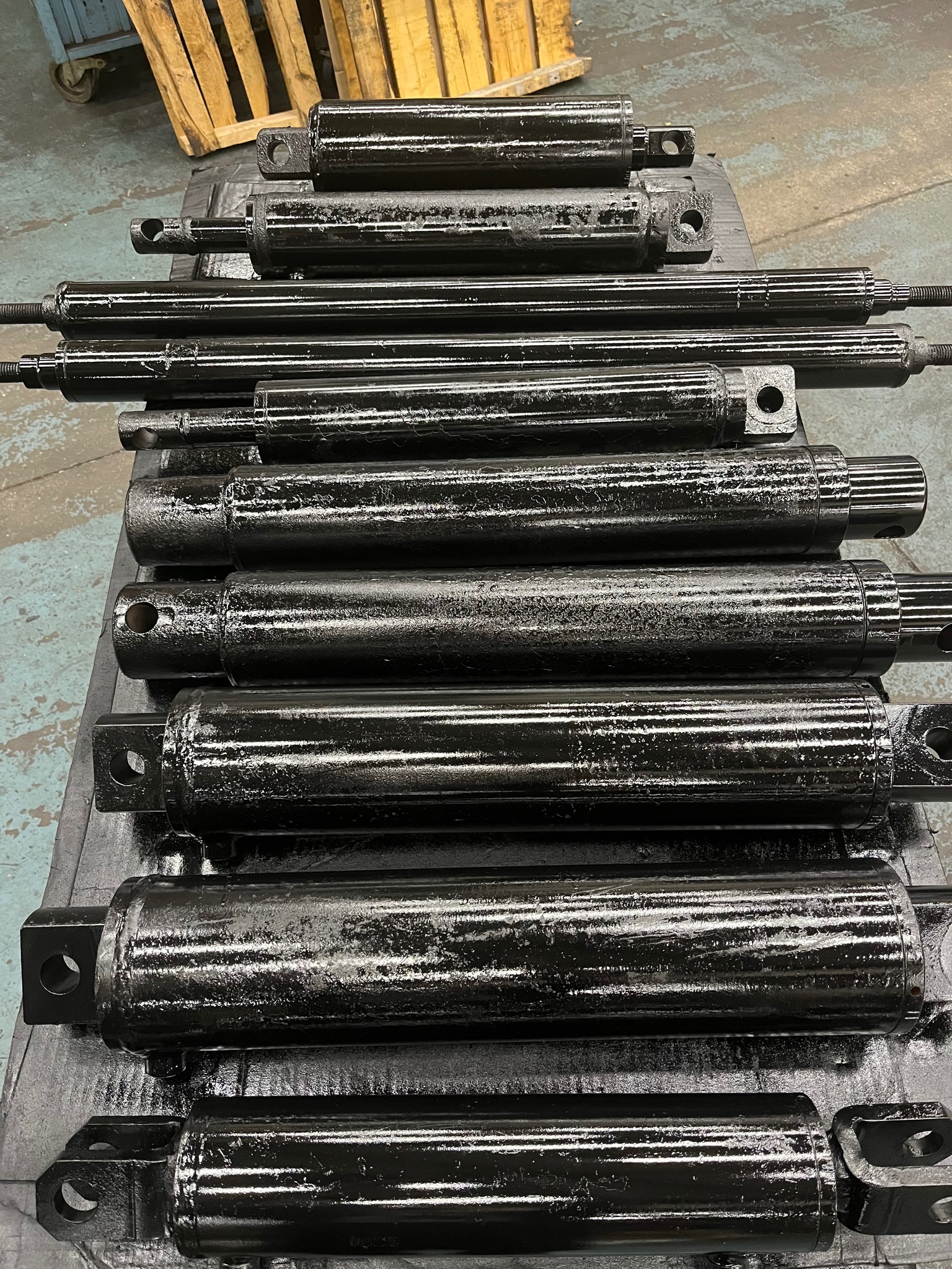 Row of rebuilt hydraulic cylinders ready for delivery